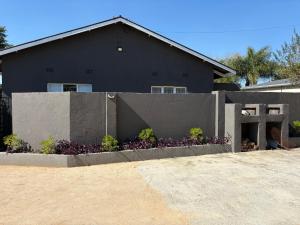 a black house with a fence in front of it at Phapel Home-Away in Pretoria