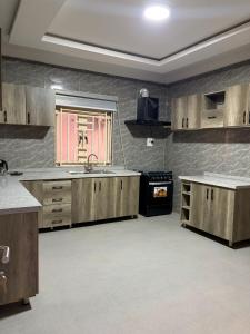 a large kitchen with wooden cabinets and a sink at Lochwood in Aso