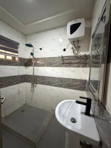 a bathroom with a shower and a sink at Lochwood in Aso +13 photos