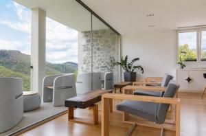 a room with tables and chairs and a large window at Arantza Hotela - Boutique Hotel "Adults Only" in Arantza