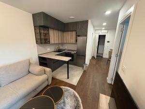 a living room with a couch and a kitchen at Tesla Palace III in Kragujevac
