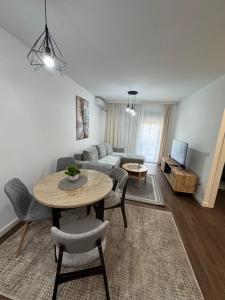 a living room with a couch and a table at Tesla Palace III in Kragujevac