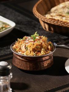 a dish of food sitting on top of a table at Hotel Rs Inn - 5 Mints Walk From New Delhi Railway Station And Connaught Place in New Delhi +34 photos
