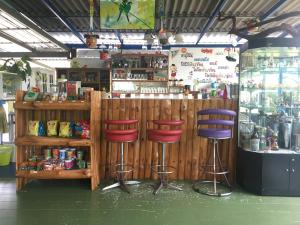 a store with two stools in front of a bar at Kum Nangpaya in Kaeng Krachan
