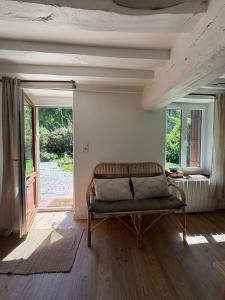 a room with a couch in a room with windows at Le Clos du Avre - Maison calme & jardin verdoyant in Breux-sur-Avre
