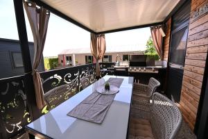 a table and chairs on the balcony of a house at L&A Mobile House in Metlika