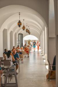 a group of people sitting at tables in a building at Hôtel Hammamet Beach in Hammamet
