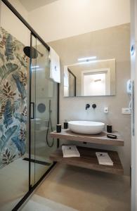 a bathroom with a sink and a shower at Monnalisa Rooms in San Vito lo Capo +90 photos