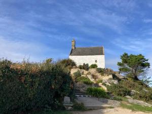 a church on the side of a hill at Les Chambres de Kermenguy in Sibiril
