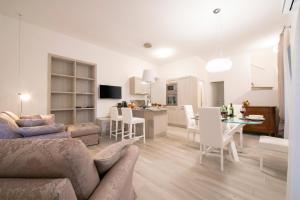 a living room and kitchen with a couch and a table at Lenno Giardinetto in Lenno