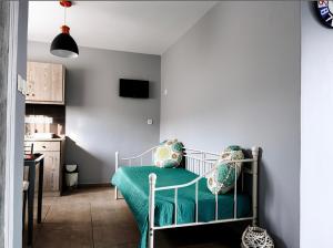 a bedroom with a bed with a green bedspread at Aegli House in Theológos
