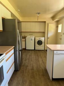 a kitchen with a refrigerator and a washer and dryer at 6 bedroom house in Victoria