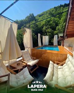 a living room with a pool and chairs and a table at Lapera Otel in Borçka +2 photos