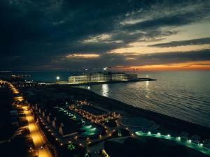 a view of a beach at night with lights at Sea Breeze Baku in Baku