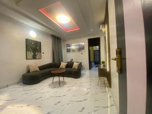 a living room with a couch and a table at Spenza Hotel and Suites in Asaba