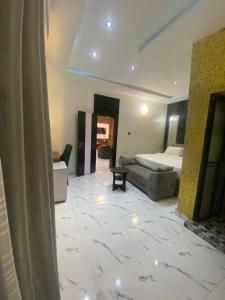 a large room with a bed and a couch at Spenza Hotel and Suites in Asaba +2 photos