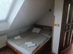a bed in a room with two towels on it at Apartmán Penzion Sigma in Dolní Žďár +10 photos