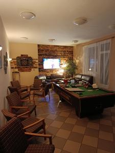 a living room with a pool table and chairs at Apartmán Penzion Sigma in Dolní Žďár