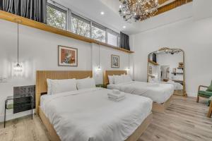 a bedroom with two beds and a mirror at La Sainte Paix in Quebec City