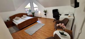 a living room with a bed and a desk at The HOME in Ditrău