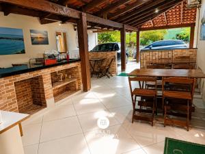 a room with a table and chairs in a house at Pousada Família Cordeiro - Penha/SC in Penha