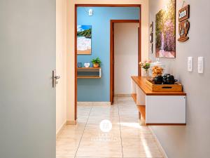 a kitchen with a blue door and a counter at Pousada Família Cordeiro - Penha/SC in Penha