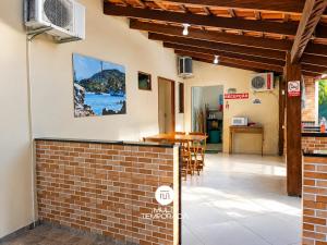 a view of the outside of a house with a brick wall at Pousada Família Cordeiro - Penha/SC in Penha +11 photos