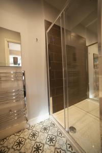 a shower with a glass door in a bathroom at Modern Studio - Central Location in Southport
