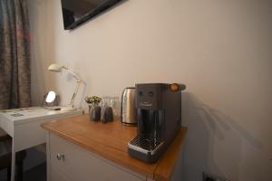 a coffee maker sitting on top of a wooden counter at Modern Studio - Central Location in Southport