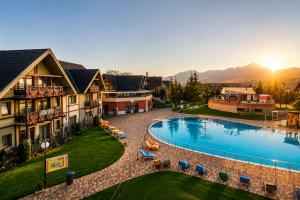 an aerial view of a resort with a swimming pool at Komnata Bešeňová - Apartmán 344 in Bešeňová