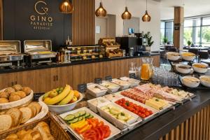 a buffet line with different types of food at Komnata Bešeňová - Apartmán 344 in Bešeňová
