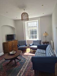 a living room with a couch and chairs and a table at AbbeyLane house in Trim