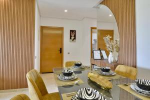 a dining room with a table and chairs at Marrakech Golf Luxury in Marrakesh +36 photos