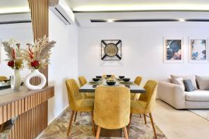 a dining room with a table and chairs and a couch at Marrakech Golf Luxury in Marrakesh