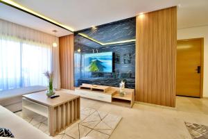 a living room with a couch and a television at Marrakech Golf Luxury in Marrakesh