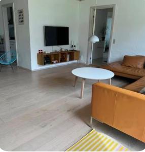 a living room with a couch and a table at Cozy house in Hasseris in Aalborg