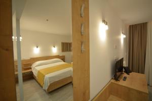 a hotel room with a bed and a television at Eluize Inn Dubrovnik in Dubrovnik +17 photos