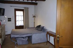 a bedroom with a bed in a room with a window at Roby's House in Gaiole in Chianti +8 photos
