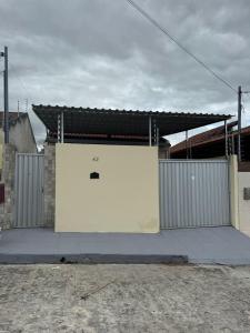 a large white garage door in front of a building at Casa confortável para o são joão in Campina Grande
