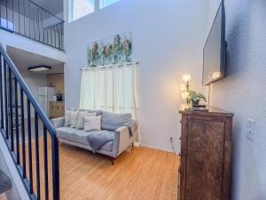 a living room with a couch and a television at Charming 2nd Ave Lofts in Downtown San Diego with Parking in San Diego