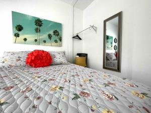 a bedroom with a bed with a red flower on it at Stay Near Miami's Cultural Heart With Wifi in Miami