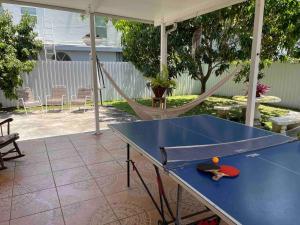 a blue ping pong table with a ball on it at Stay Near Miami's Cultural Heart With Wifi in Miami