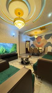 a room with two beds and a flat screen tv at Etoile de Nathalice in Kinshasa