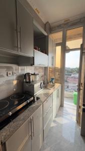 a kitchen with white cabinets and a counter top at Etoile de Nathalice in Kinshasa