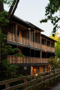 a house with wooden balconies and a fence at New Paltz Way Hotel in New Paltz