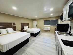 a hotel room with two beds and a sink at AC Suites in Atlantic City
