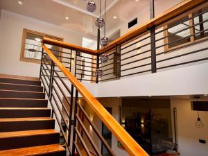 a staircase in a house with wooden railings at Cumaé Hotel Boutique in Quimbaya +3 photos