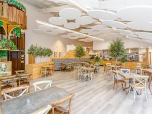 a restaurant with tables and chairs in a room at Pine Lodge Spa in Thirsk