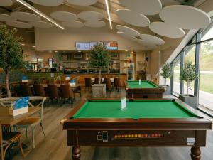 a room with a pool table in a restaurant at Pine Lodge Spa in Thirsk