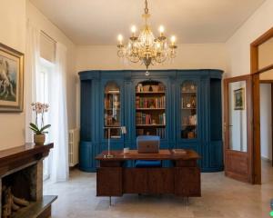 an office with blue walls and a desk with a laptop at Simohouse Lecce - Executive Suite Apartment 140mq - 2 Bathrooms in Lecce